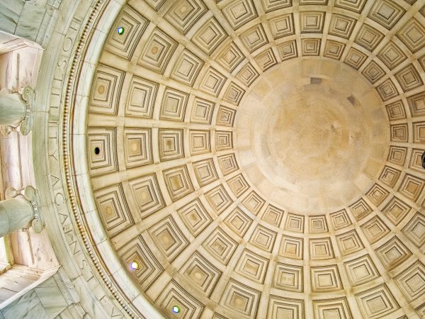 A low-angle view of the classical dome ceiling inside the Jefferson Memorial.