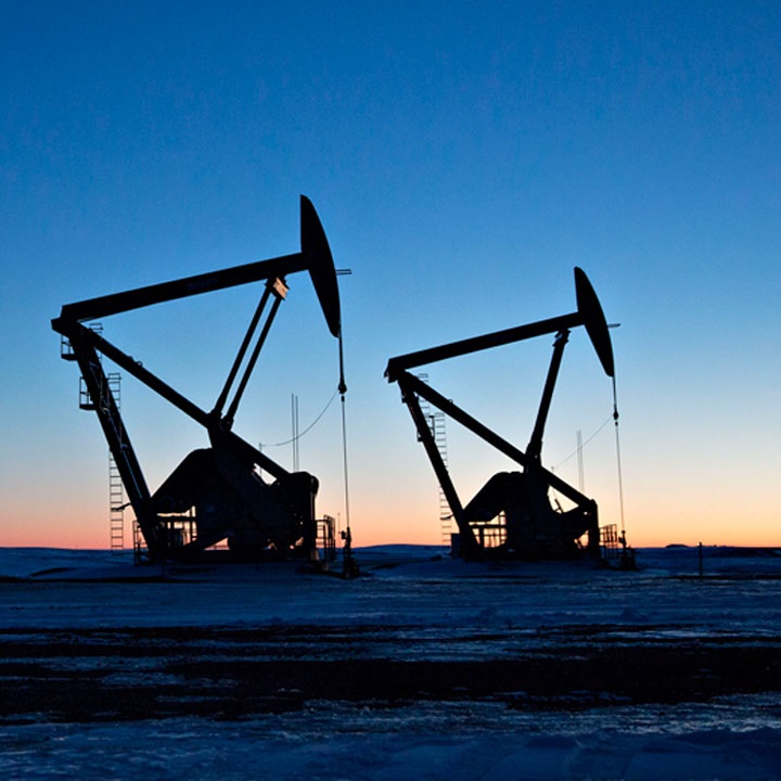Photograph of oil pumps at sunrise.